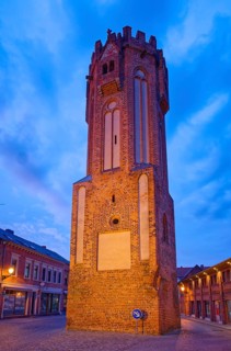 The brick Gothic Owl Tower, illuminated at night, in the old town centre of Tangermünde, Hanseatic