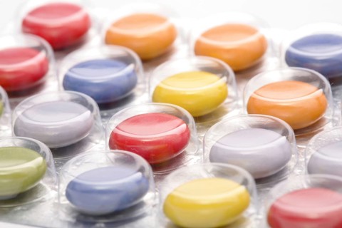 Colourful tablets packed in plastic, tablet addiction, drug addiction, studio
