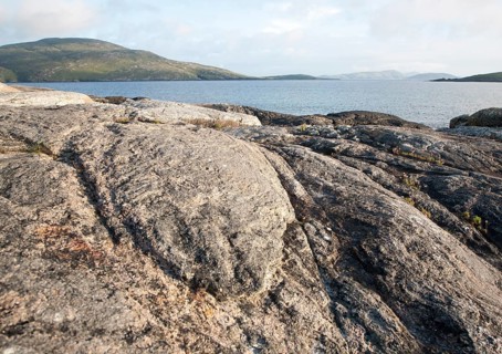 View to Sandray Island from rocky headland at Bagh a Deas, South Bay, Vatersay island, Barra, Outer