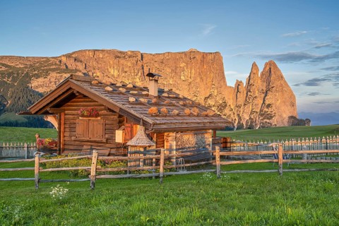 Alpine hut in front of Schlern, sunrise, blue sky, Seiser Alm, Dolomites, South Tyrol