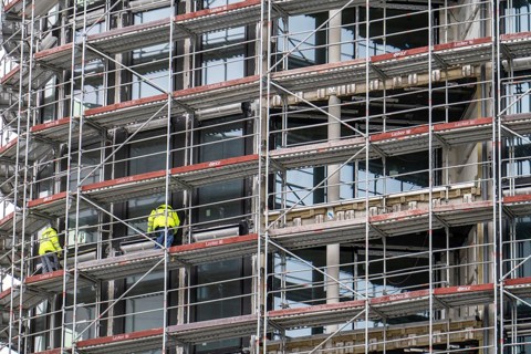 Large construction site, construction of a residential building with many flats, scaffolding,