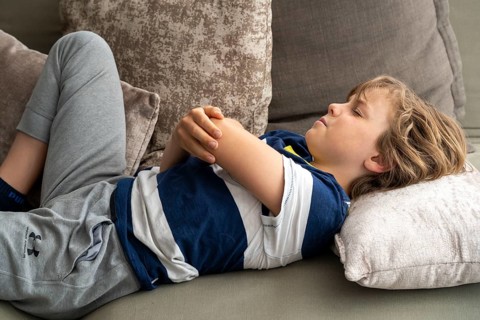 Growing pains in children, boy, 10 years old, has pain in his arm, symbolic picture