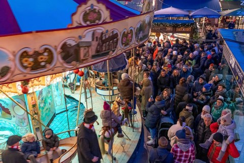 Historic horse-drawn carousel at the Christmas market on the Heumarkt in the old town of Cologne,