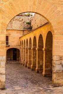 Archway and arcades at the Portal de des Tales in the old town of Eivissa, Ibiza Town, Ibiza,