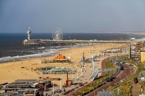 View over the beach of Scheveningen, the pier with Ferris wheel belongs to the city of The Hague