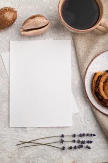 White paper invitation card, mockup with lavender, bun, cup of coffee, linen textile, seashell on