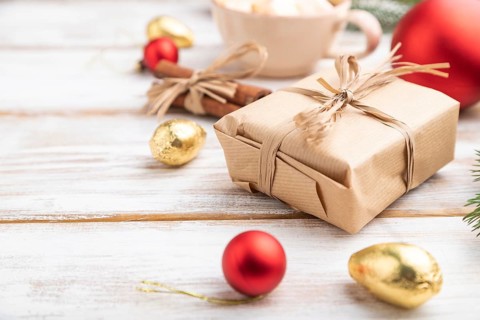 Christmas or New Year composition. Decorations, box, red balls, cinnamon, fir and spruce branches,