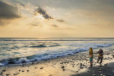 Muslim woman in the evening sun at Mangsit beach in Sengiggi, Islam, religion, headscarf, travel,