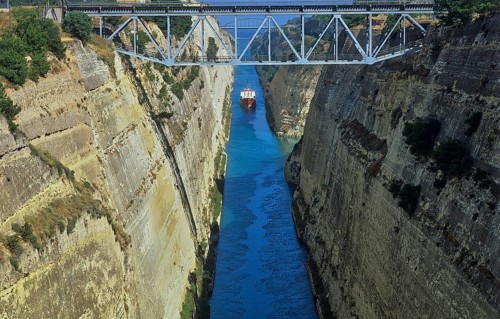 View of a ship navigating through a narrow channel with steep, rocky walls, Corinth Canal, Corinth,