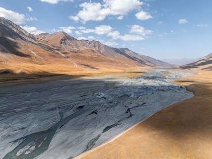 Aerial view, Burkhan mountain valley with meandering river, barren dramatic mountain landscape,