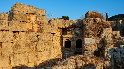 Ancient stone ruins with a small opening and visible sky above, Peirene Fountain, Archaeological