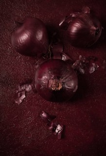 Red onion, fresh, raw, on a dark background, top view