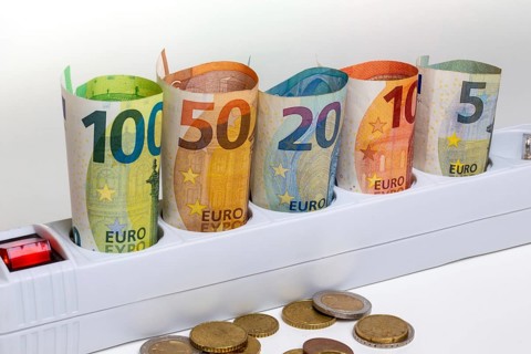Symbolic image of electricity costs: Multiple socket outlet with banknotes