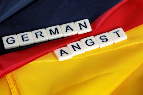 Symbolic image of German Angst: letter cube on a German flag
