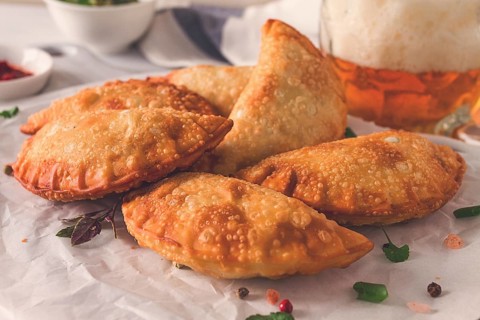 Fried chebureks, close-up, on a light background, no people