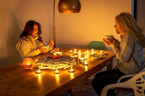 Symbolic image energy saving, cold winter, energy crisis, cold flat, mother and daughter dressed
