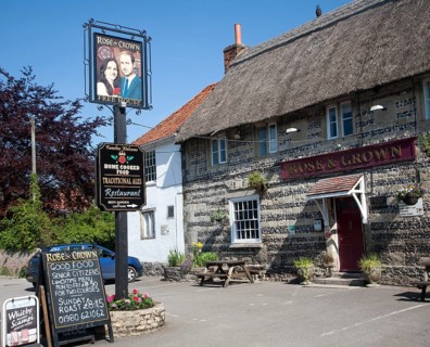 Rose and Crown pub, Tilshead, Wiltshire, England, UK, sign of Prince William and his wife Kate