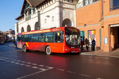 Red single decker bus Mainline 66 route to Martlesham Tesco passengers boarding in town centre,
