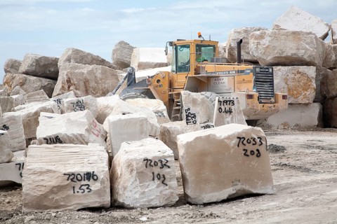 Heavy machinery at work in a stone quarry on the Isle of Portland, Dorset, England, UK