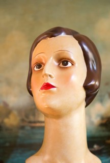 Female mannequin head close up 1920s haircut style, inside antiques centre, Marlesford Mill,