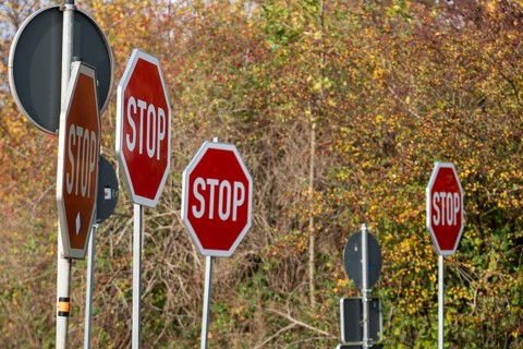 Several STOP signs next to each other, traffic signs
