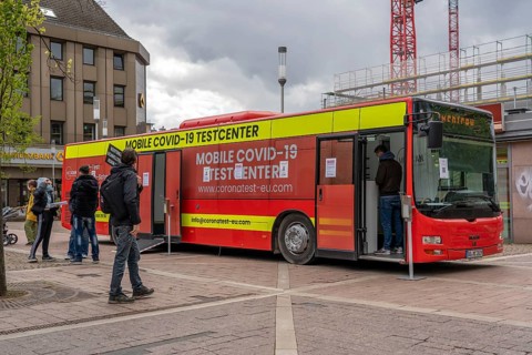 Mobile test centre for Corona rapid tests, in a bus, in the city centre of Bochum, North