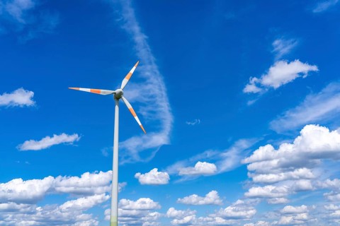 Wind turbine, wind energy plant from the manufacturer Enercon, blue sky with many white clouds,