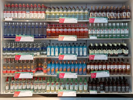 Shelves with bottles of alcohol World Duty Free shop, Stansted airport, Essex, England, UK