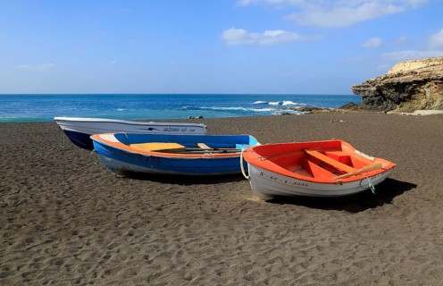 Colourful boats on black sand beach at Ajuy, Fuerteventura, Canary Islands, Spain, Europe