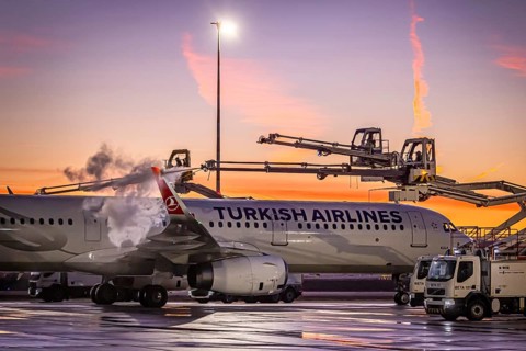 Frost at the airport, a Turkish Airlines aircraft is de-iced in front of sunrise. Airbus A321-231,