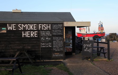 Sheds selling fresh and smoked fish on the beach at Aldeburgh, Suffolk, England, UK