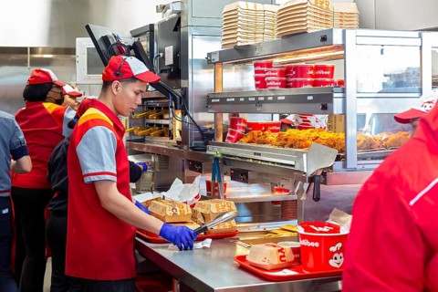 Sterling Heights, Michigan, Workers serve up Chickenjoy fried chicken at Jollibee, a Filipino fast