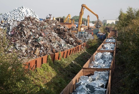 Scrap metal recycling loading train wagons with processed metals, EMR company, Swindon, England, UK