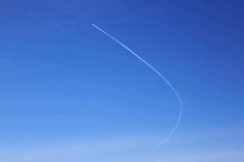 Contrail of airplane outlined in clear blue sky over Suffolk, England, UK