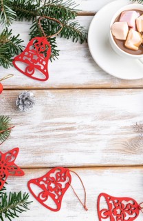 Christmas or New Year frame composition. Decorations, red stars, bells, cones, fir and spruce