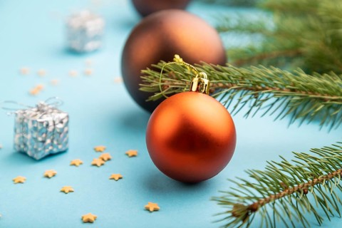 Christmas or New Year composition. Decorations, bronze balls, fir and spruce branches, on a blue