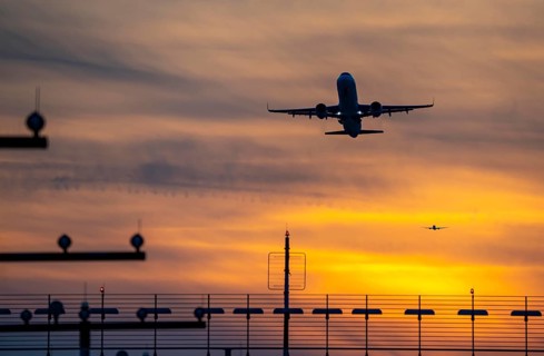 Runway lighting, approach aids, at Düsseldorf International Airport, sunset, aircraft taking off