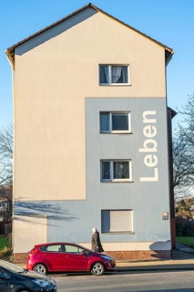 Residential buildings, rented flat, façade with the inscription Leben, on Adolf-Schmidt-Strasse,
