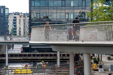 Cyclists on the Cykelslangen cycle and pedestrian bridge, at the Fisketorvet shopping centre,