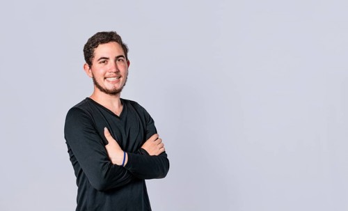 Happy handsome man with crossed arms, portrait of an attractive guy with crossed arms on isolated