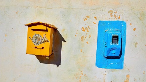 Yellow post box, Blazer electricity meter, house wall, Flomochori, residential tower village, Mani