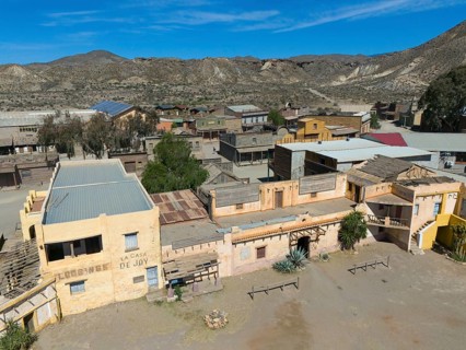 An abandoned western town in a dry desert landscape in sunny weather, aerial view, Fort Bravo,