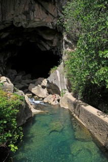 Person exploring entrance ot cave, Cueva del Gato, Benaojan, Serrania de Ronda, Malaga province,