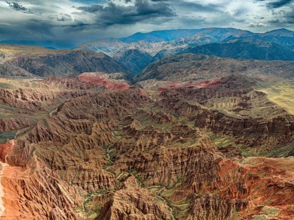 Eroded mountain landscape, canyon with red and orange rock formations, aerial view, Konorchek