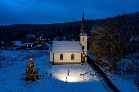 A Christmas tree stands in front of the smallest wooden church in Germany, Elend, 29 December 2020