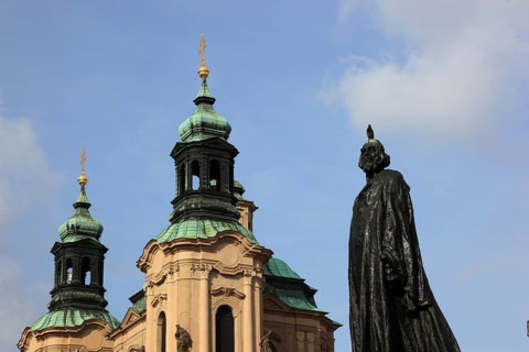 Jan Hus Monument on Old Town Square and the baroque St Nicholas Church, Prague, Czech Republic,