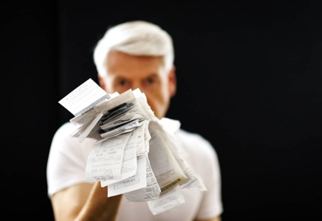 The subject of taxes. A man holds receipts in his hand in Berlin, 09/08/2024