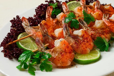 Shrimp kebab, with spices, lime, on wooden skewers, top view, no people