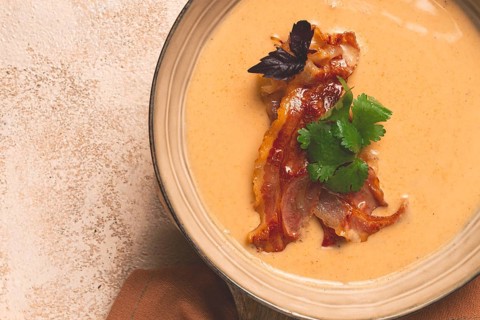 Pumpkin cream soup, curry, fried bacon, top view, no people