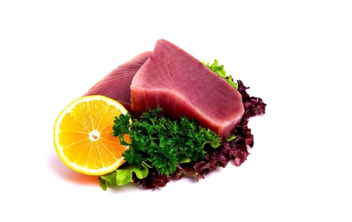 Raw steak, tuna fish, on a white background, close-up